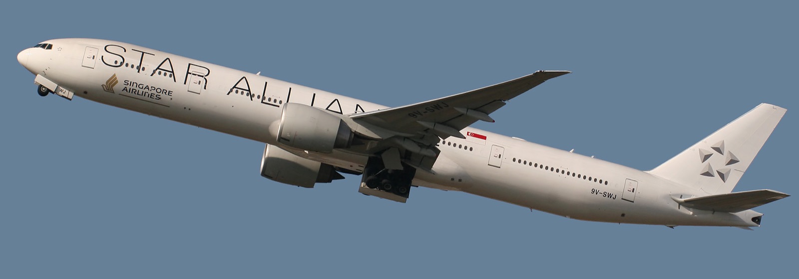 A Singapore Airlines Boeing 777-300ER in Star Alliance livery climbing after takeoff