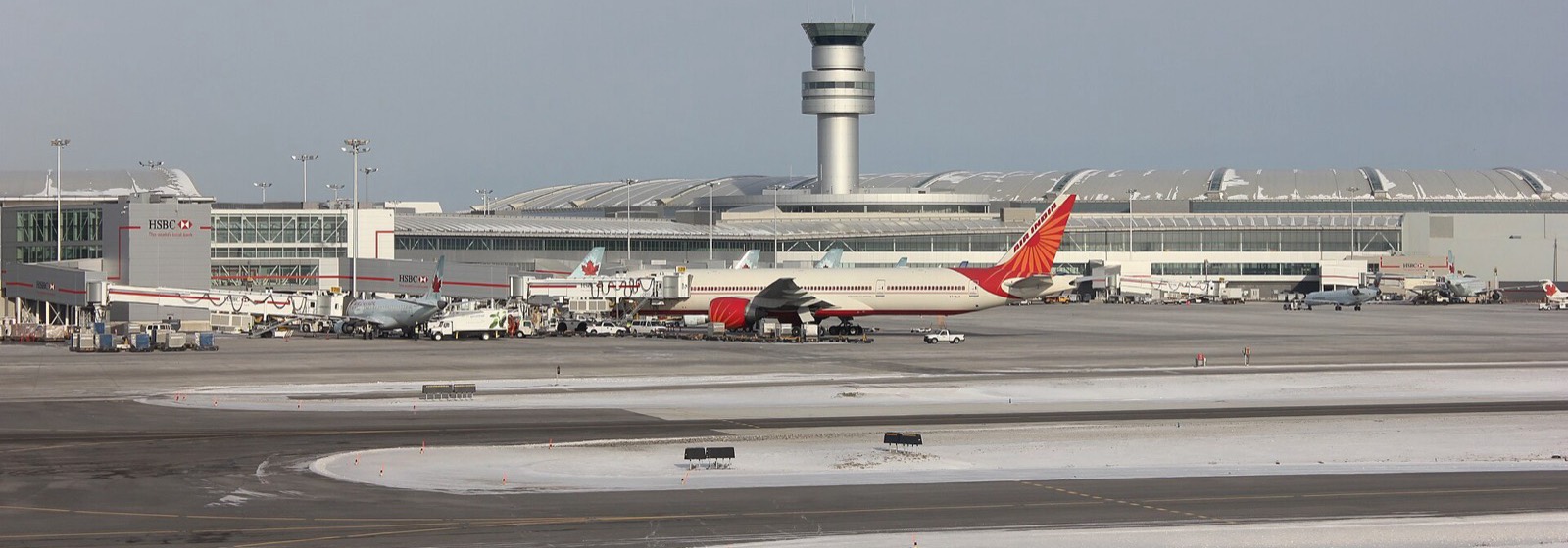 Aircraft at the gates of Toronto Pearson airport, with Air Canada jets and the control tower, in winter